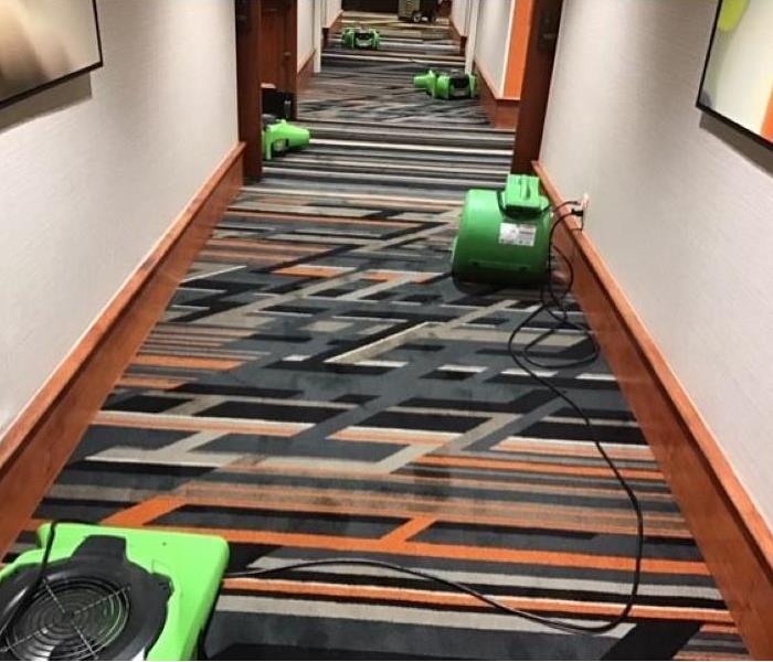 Large hotel hallway after having water extracted and air movers set