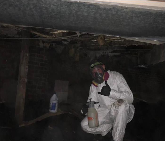 Our technician Greg in full PPE in a customer crawlspace