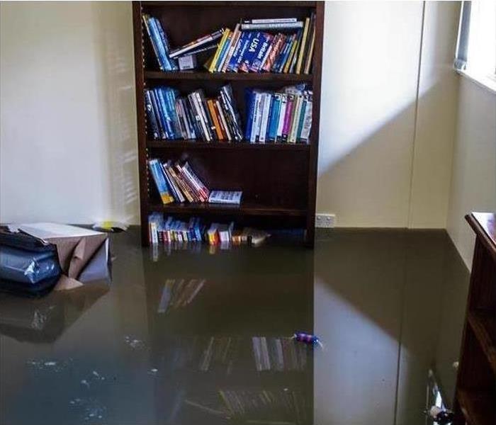 Bedroom with flood water up across several shelves
