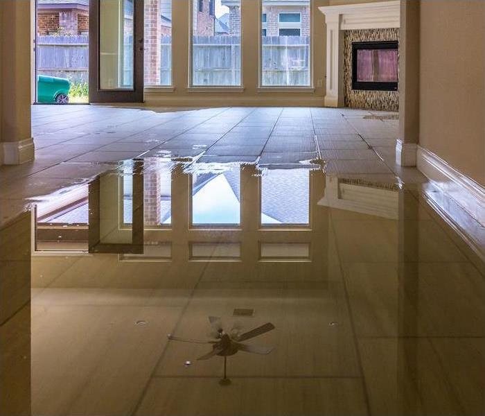  img src =”water” alt = " a large puddle of water in the midde of a lobby reflecting the ceiling” >